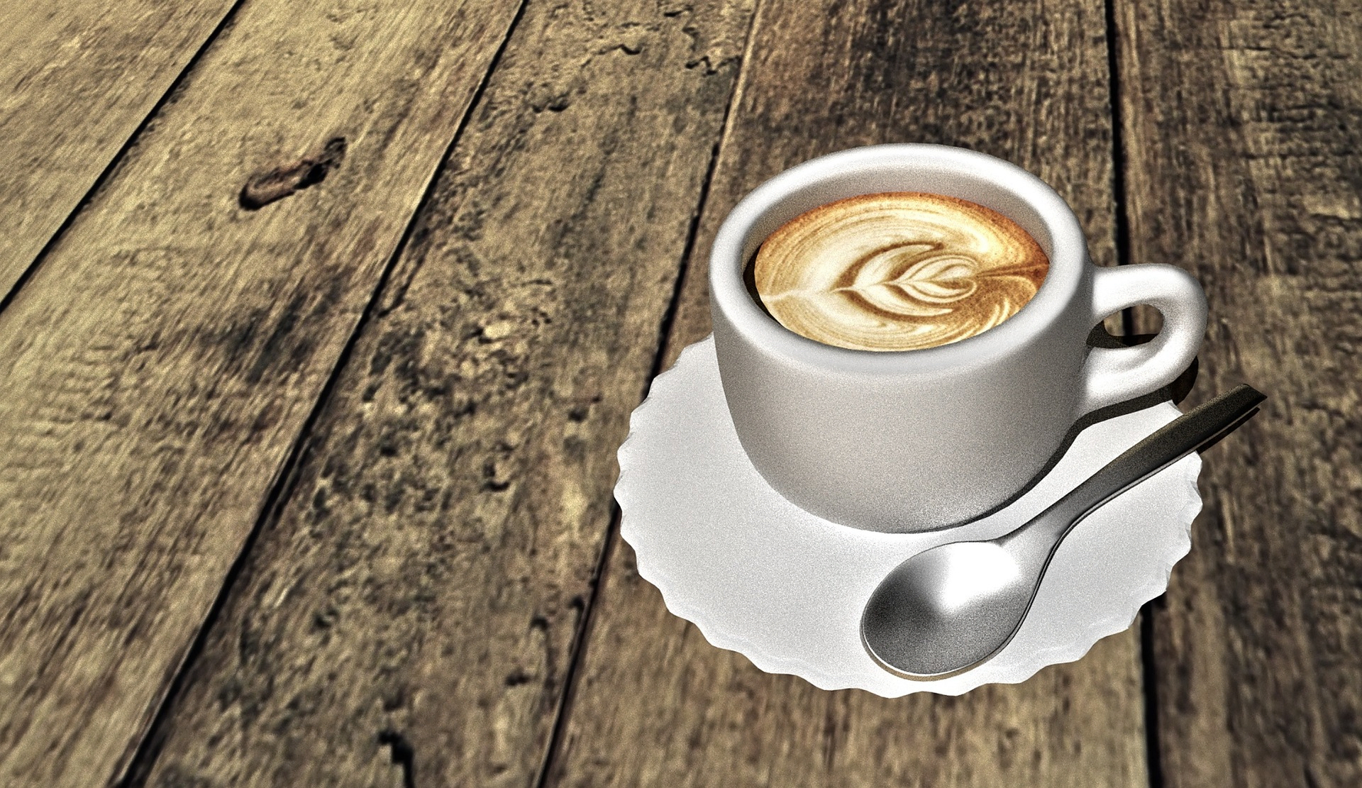 Taza de café expreso con arte latte, servida sobre una mesa de madera rústica con cucharilla.